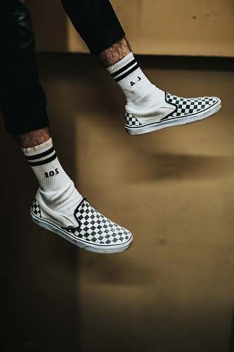 los angeles person wearing white-and-black checked slip-on shoes shoe